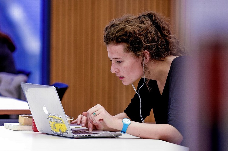 Female student works on a laptop